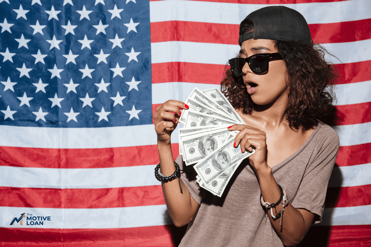 Excited woman holding cash after getting approved for a personal loan through The Motive Loan